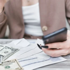 Creadora revisando en el celular cómo cobrar OnlyFans en Argentina
