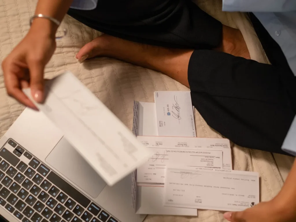 Creadora revisando comprobantes junto a su notebook para emitir la factura E de OnlyFans en Argentina